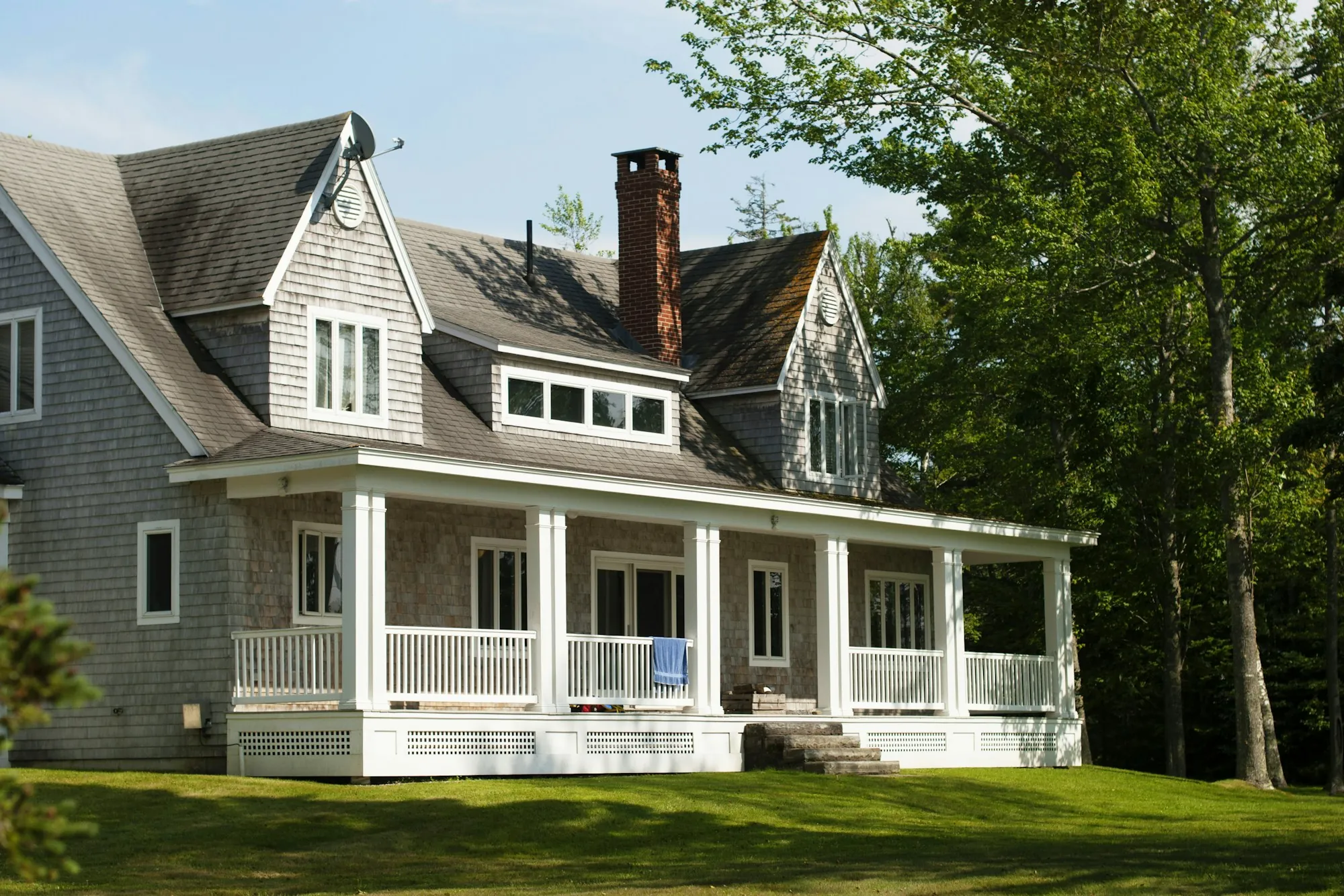 Shingle-sided house with a gray roof and long front porch